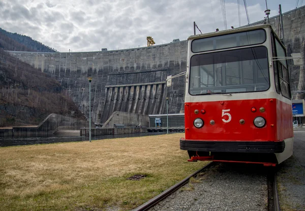 Трамвай на фоне плотины Саяно-Шушенской гидроэлектростанции — стоковое фото