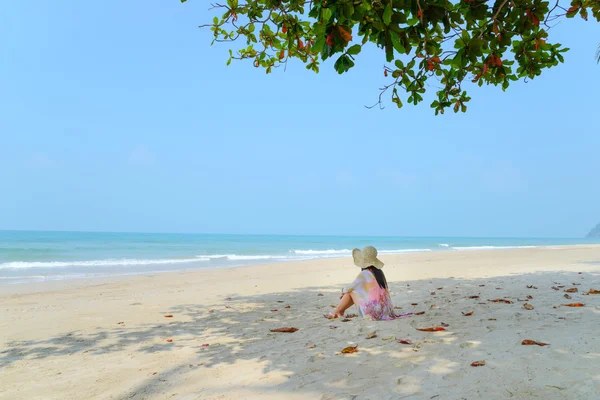 Jeune femme se détendre sur la plage tropicale regardant vers la mer — Photo