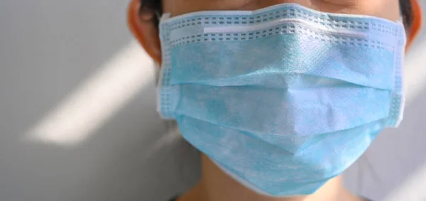 woman wearing protection face mask against coronavirus or 2019-nCoV virus. Girl in medical mask protect of air pollution and virus epidemic of covid 19. Banner panorama and copy space