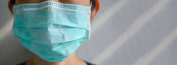 woman wearing protection face mask against coronavirus or 2019-nCoV virus. Girl in medical mask protect of air pollution and virus epidemic of covid 19. Banner panorama and copy space