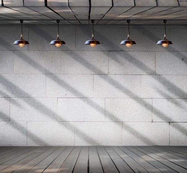 Lamp at Grungy concrete wall with wood floor