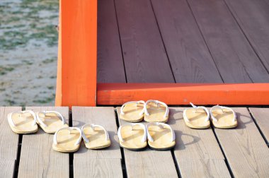 Five pairs of sandal on the floor at Itsukushima Shrine, Miyajima Island clipart