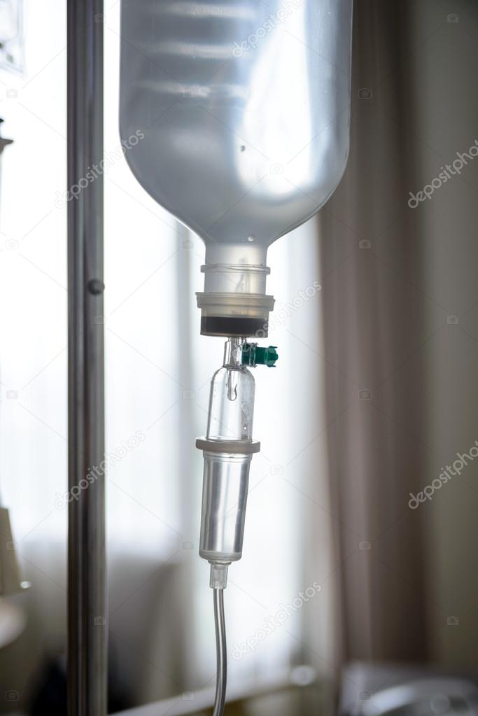 Close up IV saline solution drip for patient in hospital