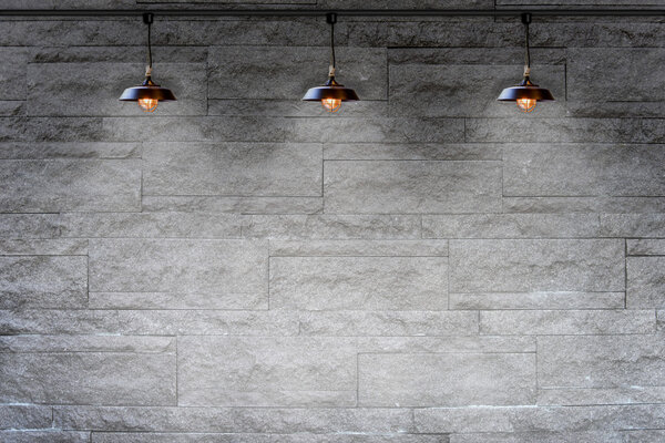 Гранитная каменная кирпичная стена с лампой
