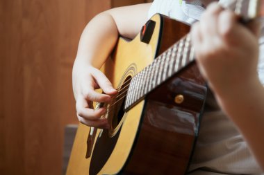 Küçük çocuk gitar çalıyor