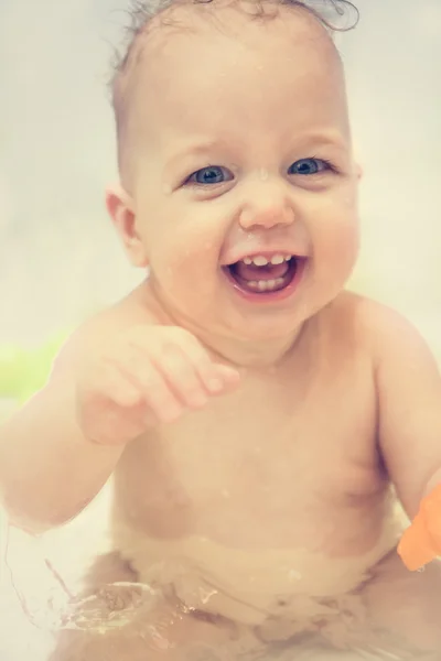 Cheerful laughing baby having a bath — Stock Photo, Image