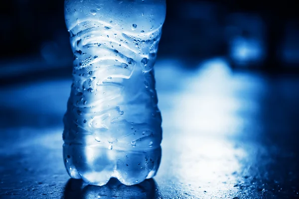 Bottle of  pure water with condensate drops and back light — Stock Photo, Image