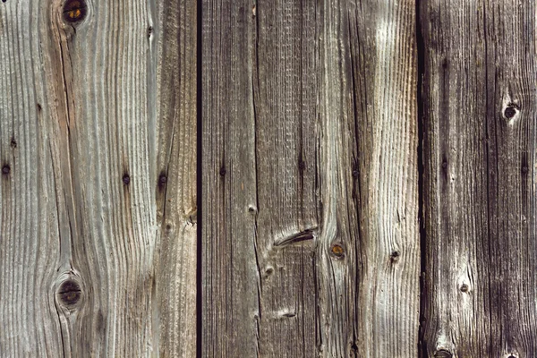 Obsolete fence with vertical boards and nails — Stock Photo, Image