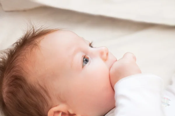 Curious baby lying in bed — Stock Photo, Image