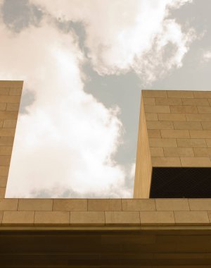 Yellow building on a background of blue sky. Urban background. Minimalism.