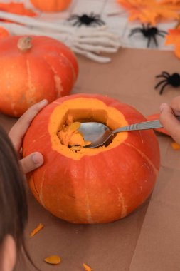 Scooping pumpkin guts for Halloween fun!