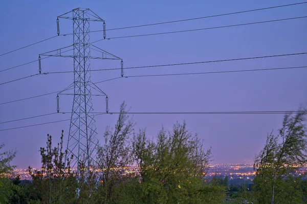 Beautiful early morning view of power lines with electricity transmission pylon against epic sky before sunrise in Ticknock Forest National Park, County Dublin, Ireland. Soft and selective focus