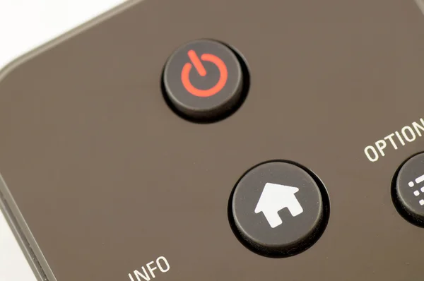Red power button  and a white home button on a remote control — Stock Photo, Image