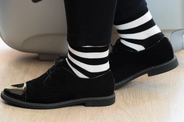 Walking concept with elegant black leather shoes and black and white striped socks — Stock Photo, Image