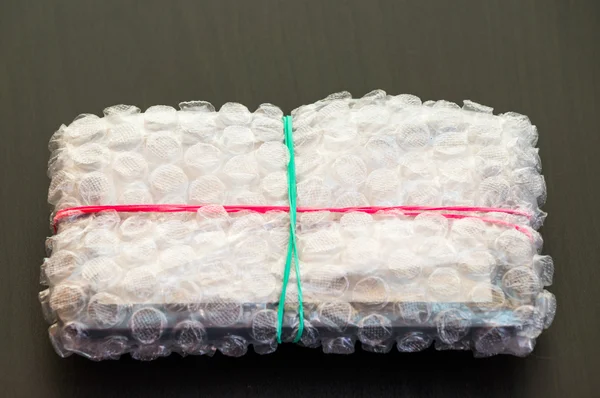 Packed and sealed electronic device in bubble wrap — Stock Photo, Image
