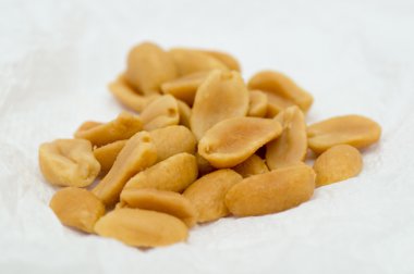 Macro shot of roasted ans salted peanuts clipart