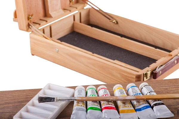 Acrylic paints on an easel — Stock Photo, Image