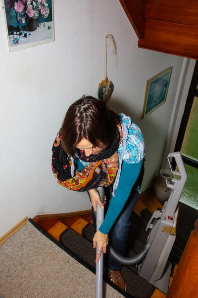 Woman vacuuming a hallway — Stock Photo, Image