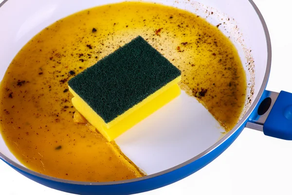 Sponge in clean a frying pan — Stock Photo, Image