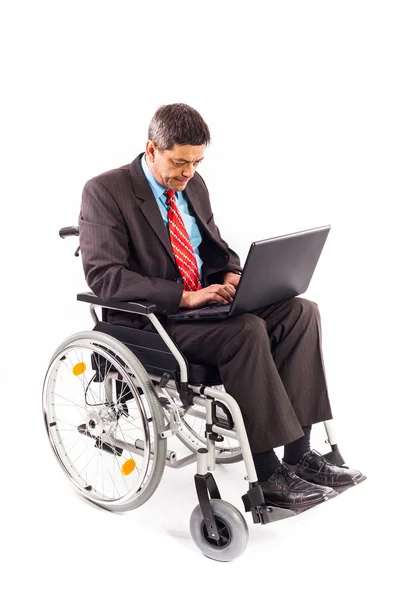 Man in a wheelchair with laptop — Stock Photo, Image