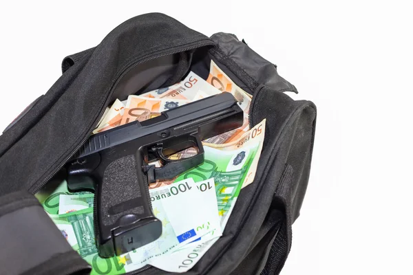 Loot from bank robbery - Sports bag full of money with gun-cutout Royalty Free Stock Photos