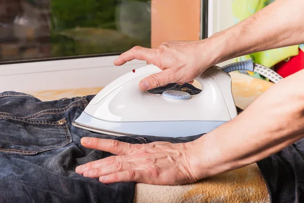 Men hands ironing clothes — Stock Photo, Image