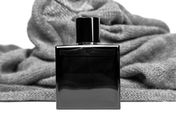 Bottle of men perfume and gray scarf — Stock Photo, Image