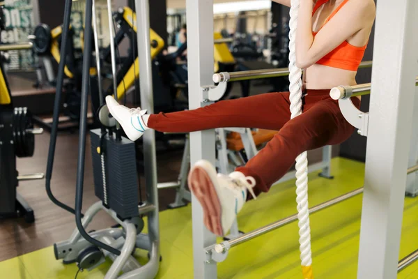 在健身房健身俱乐部的战斗绳子上挂着的女人 — 图库照片