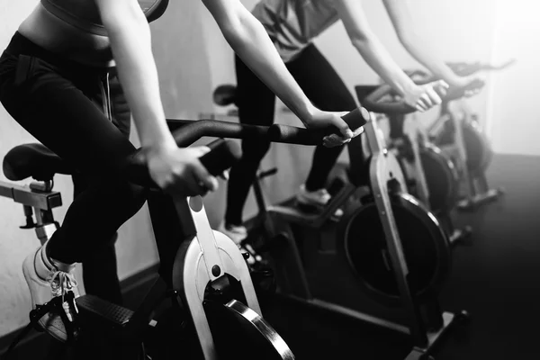 Woman on fitness exercise bike at indoor — Stock Photo, Image