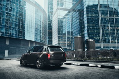 Sigorta primi araba Land Rover Range Rover ayakta modern şehrin gündüz bina yakınındaki