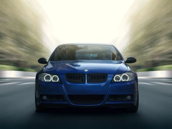 Blue car BMW 5 series E90/E91 Fast speed drive on city road — Stock Photo, Image
