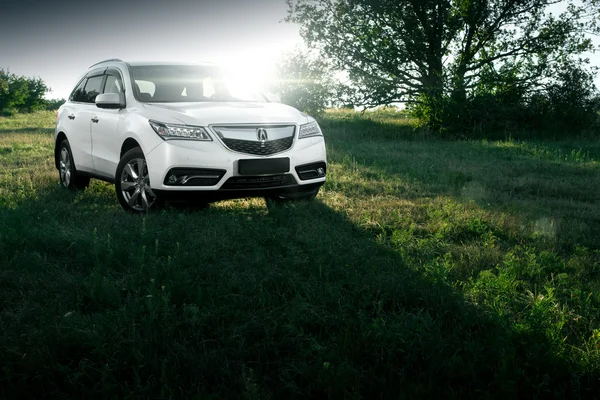 Modern car Acura MDX standing on road at sunset — Stock Photo, Image