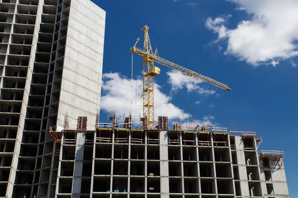 Construcción de grúas ladrillos edificio de hormigón en la ciudad —  Fotos de Stock