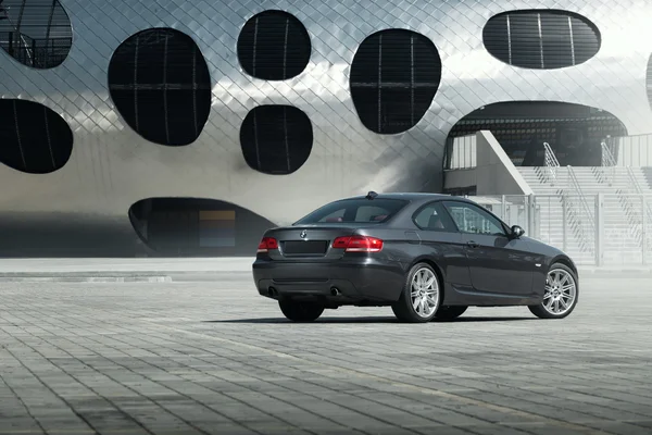 Car BMW Coupe E92 standing on sett empty parking lot near modern building at daytime — Stock Photo, Image