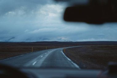 Yoldaki arabayı sür. İzlanda seyahati. İçeriden bak. Alacakaranlıktaki güzel İzlanda manzarası