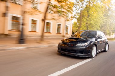 Car drive speed fast on the asphalt road green trees subaru impreza at authumn
