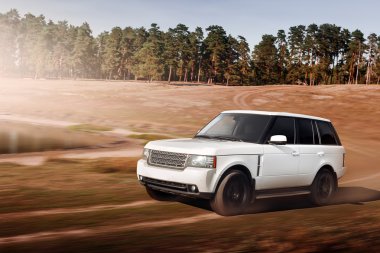 Car drive speed fast on the dirty off-road range rover