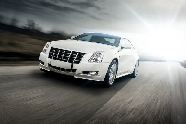 Car drive speed fast on the road at sunset cadillac Stockfoto