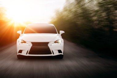 Car drive speed fast on the asphalt road lexus at sunset summertime