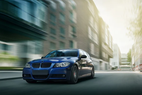 Fast drive blue bmw car speed on the road in the city — Stock Photo, Image
