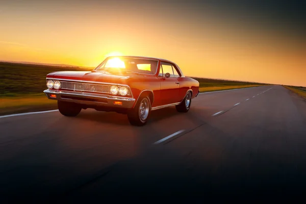 Retro car 1960s drive fast speed on the road at sunset — Stock Photo, Image