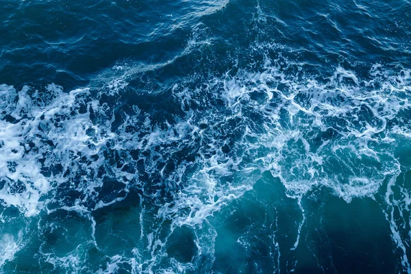 Blue sea texture with waves and foam — Stock Photo, Image