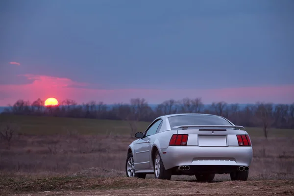 Car Ford Mustang stay on off-road at sunset — Stock Photo, Image