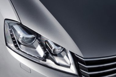 close up headlight of grey car at daytime clipart