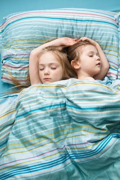 Two sisters sweet sleep holding hands