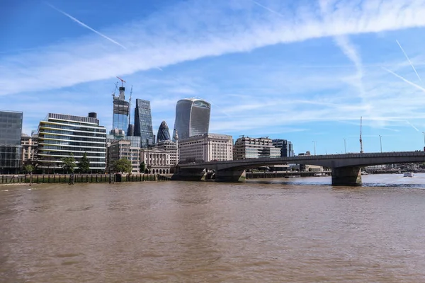 ロンドン イギリス 2018年8月11日 テムズ川の反対側に有名な高層ビルがあるロンドン市の上空の青い空の飛行機からのケムトレイル — ストック写真