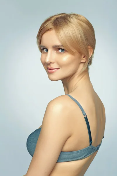 Delicate young woman wearing blue bra — Stock Photo, Image