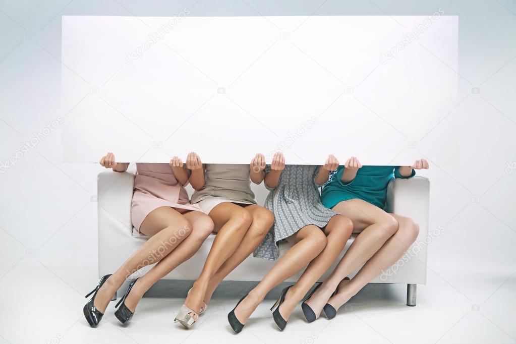 Group of girlfriends holding empty board