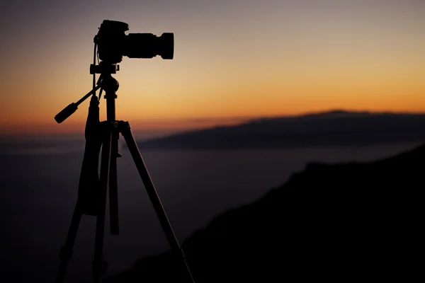 Digital camera over the sunset background — Stock Photo, Image