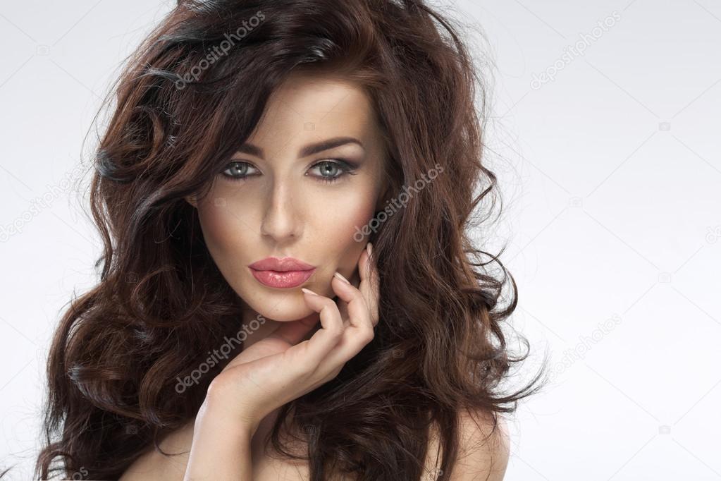 Glad young woman with a lush hairstyle